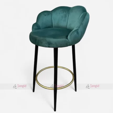 Teal velvet bar stool with metal iron legs with golden footrest ring, elegant and stylish furniture piece for modern bar.