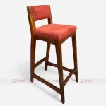 Modern wooden bar chair featuring a luxurious red upholstered seat, combining style and comfort for any setting.