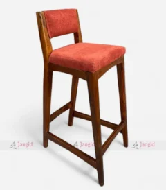Modern wooden bar chair featuring a luxurious red upholstered seat, combining style and comfort for any setting.