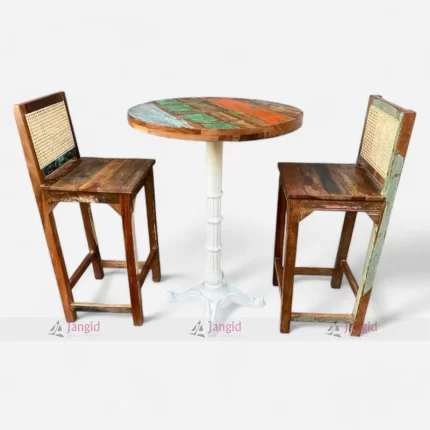 Reclaimed wood bar table and two chairs featuring cane work and circular table top.