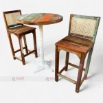 Reclaimed wood bar table and two chairs featuring cane work and circular table top.