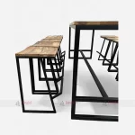 Wooden tables and stools made of rough mango wood tops and metal bases. Vintage, classic, and affordable bar furniture.