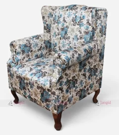 A floral wingback sofa chair featuring blue and white flowers, designed for elegance and comfort in hotel rooms or home spaces.