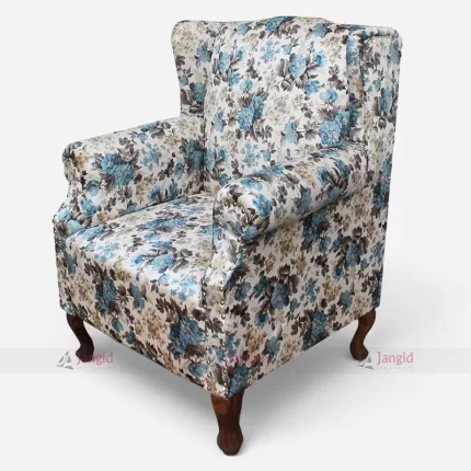 A floral wingback sofa chair featuring blue and white flowers, designed for elegance and comfort in hotel rooms or home spaces.