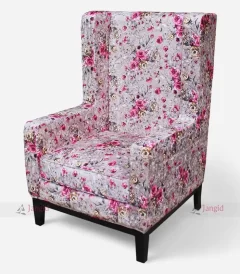 A colorful floral high wingback armchair in pink and white, perfect for adding elegance and comfort to lounges or hotel rooms.