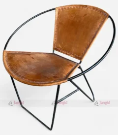 An industrial vintage chair featuring a leather seat and round metal frame, perfect for enhancing comfort and style in any setting.