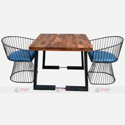 A stylish table with a recycled wood surface and cast iron legs, accompanied by two comfortable chairs dining set for cafe restaurant dining settings.