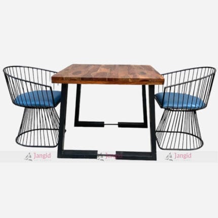 A stylish table with a recycled wood surface and cast iron legs, accompanied by two comfortable chairs dining set for cafe restaurant dining settings.
