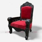Add royal elegance to your space with this single seater carved wooden sofa! Red velvet cushions, hand-carved details, and a luxurious finish. Perfect for hotels and lounges.